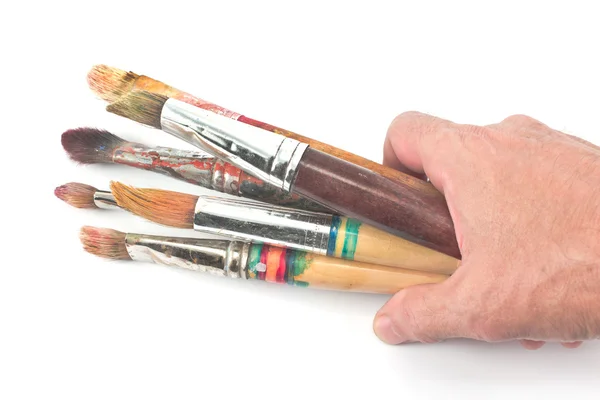 Pinceles de mano y artista usado en blanco — Foto de Stock