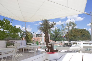 Outdoor restaurant terrace on roof with parasol