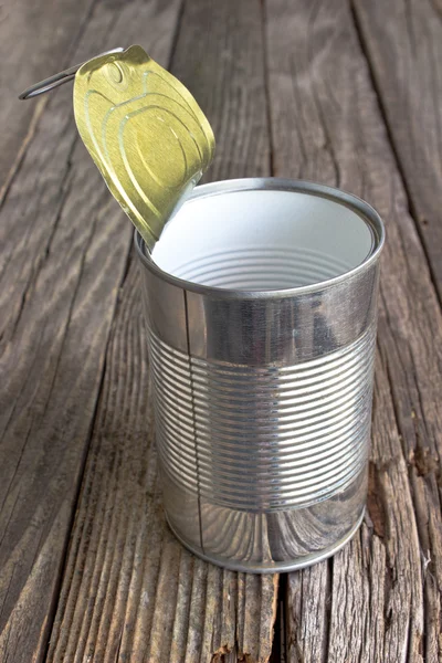Open empty tin can on wooden background — Stock Photo, Image