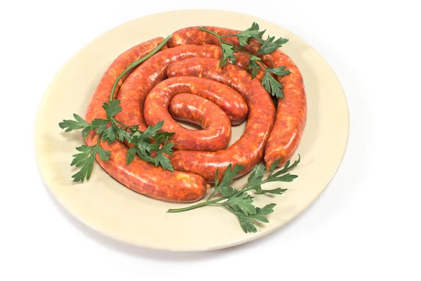 Fresh raw sausages on plate isolated on white — Stock Photo, Image