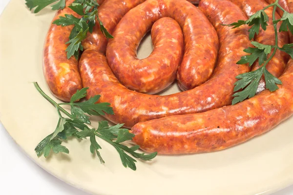 Fresh raw sausages on plate — Stock Photo, Image