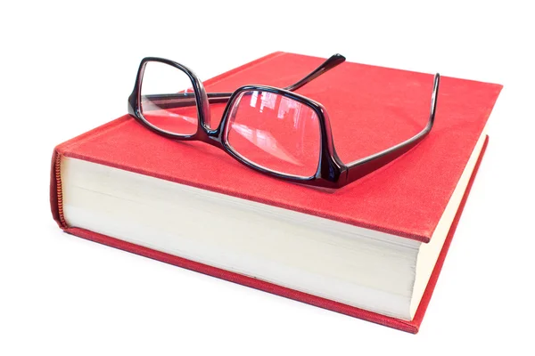 Gafas graduadas y libro aislado en blanco — Foto de Stock