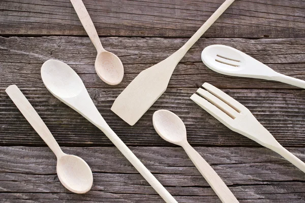 Wooden cutlery set on wooden background