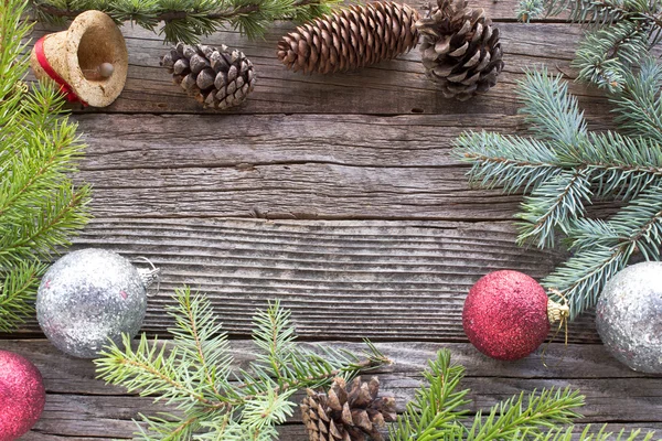 Christmas balls , pine cones and  needles on wooden background — Stock Photo, Image