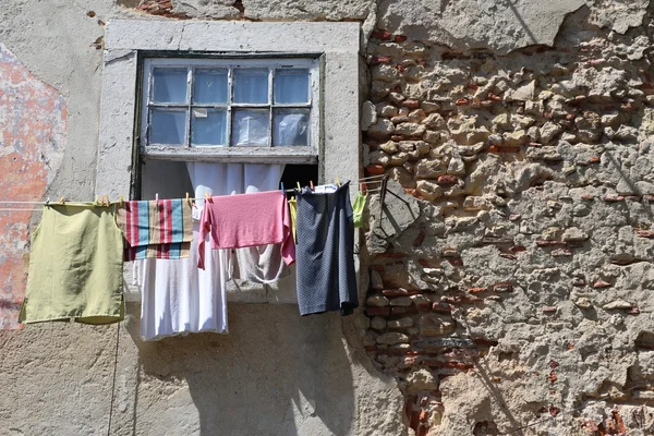 Laundry drying on a window in Lisbonl — Stock Photo, Image