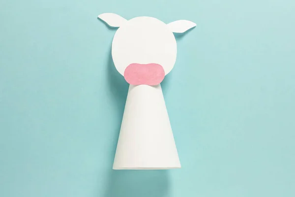 Step-by-step photo instructions on how to make a white bull from paper with your own hands. Symbol of the new year 2021. Simple crafts with children. Step 7. Glue the ears — Stock Photo, Image