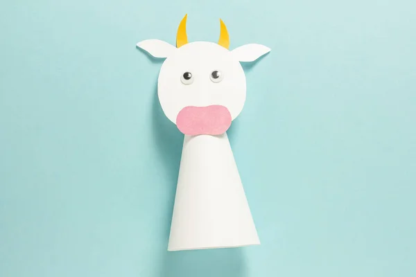 Step-by-step photo instructions on how to make a white bull from paper with your own hands. Symbol of the new year 2021. Simple crafts with children. Step 9. Glue your eyes