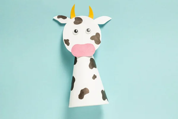 Step-by-step photo instructions on how to make a white bull from paper with your own hands. Symbol of the new year 2021. Simple crafts with children. Step 10. Glue black spots