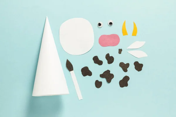 Step-by-step photo instructions on how to make a white bull from paper with your own hands. Symbol of the new year 2021. Simple crafts with children. Step 4. Cut out details — Stock Photo, Image