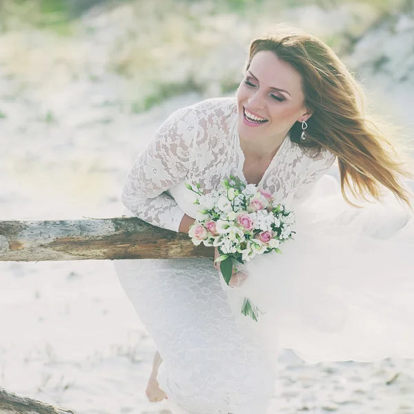 Glückliche junge Frau im Hochzeitskleid — Stockfoto