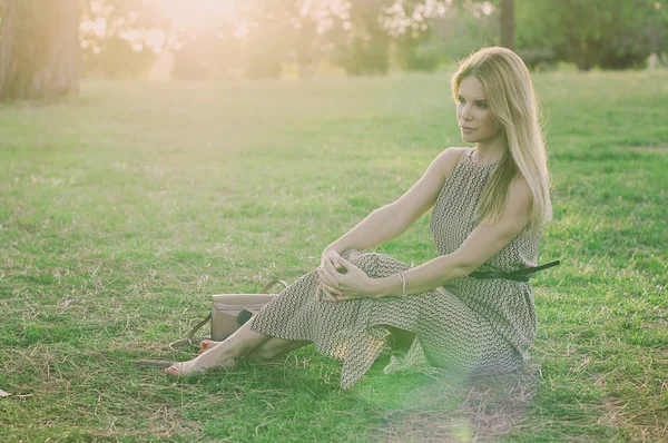 Jeune femme dans le parc du coucher du soleil — Photo