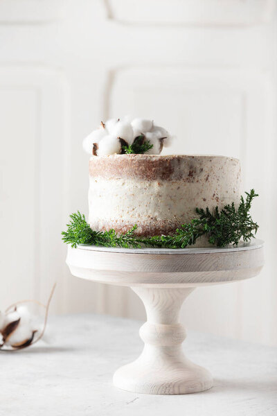 Christmas nude cake with white cream and christmas decoration, selective focus image