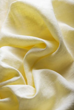 Keten kumaşın arka plan dokusu sarı renkte. Dikiş konsepti