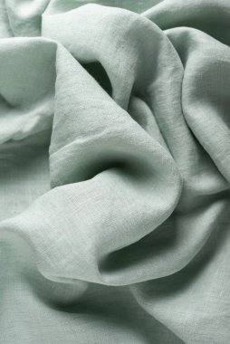 Keten kumaşın açık yeşil renkli arkaplan dokusu. Dikiş konsepti