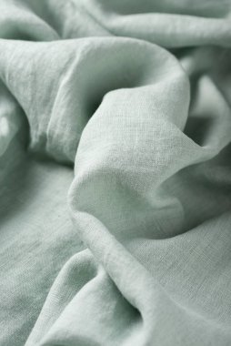Keten kumaşın açık yeşil renkli arkaplan dokusu. Dikiş konsepti