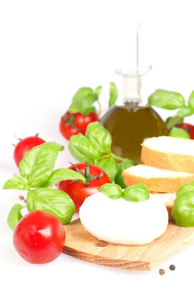 Mozzarella with basil, tomatoes and oil bottle — Stock Photo, Image