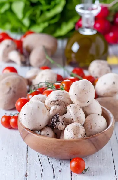 Mushrooms, oil bottle and tomatoes — Stock Photo, Image