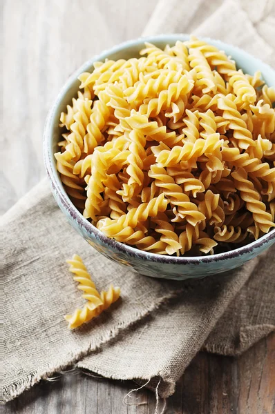 Integral raw pasta fusilli on the table