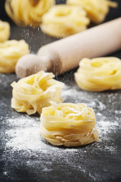 Uncooked pasta with flour — Stock Photo, Image