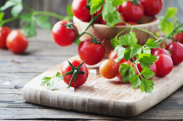 Tomatoes with green parsley — Stock Photo, Image