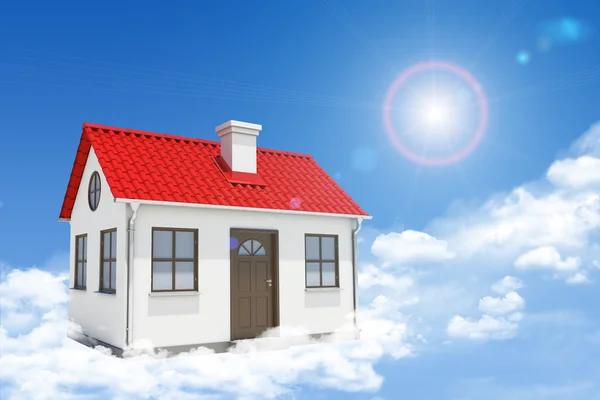 White house with red roof, brown door and chimney in clouds. Background sun shines brightly