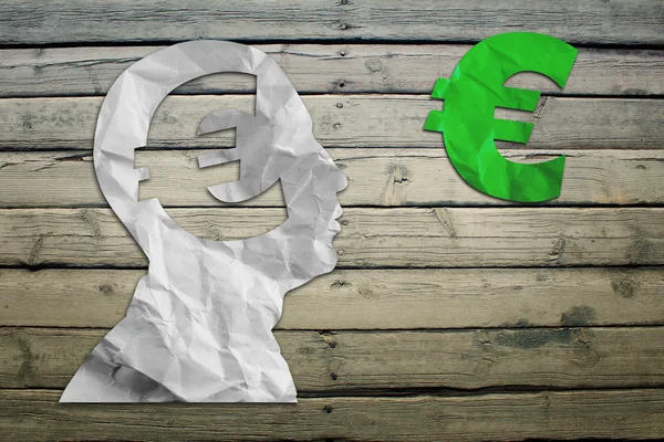 Paper humans head with euro symbol