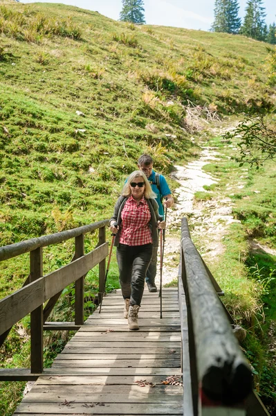 Two hiker on a wooden bridge — Stock Photo, Image