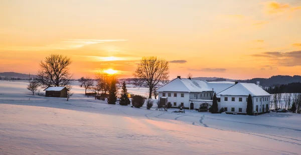 Farmhouse in a winter landscape at sunrise — Stock Photo, Image