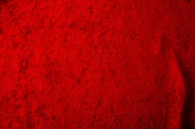 Soyut arka plan ve kırmızı kadife kumaşlı lüks kumaş konsepti, çoğunlukla esnetilmiş, ama birkaç katlı ya da metin için bolca kopya alanı olan kırışıklıklar