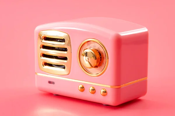Vintage technology, 70s audio equipment and live music sound system concept theme with retro radio tuner with metal chrome knob isolated on pink background