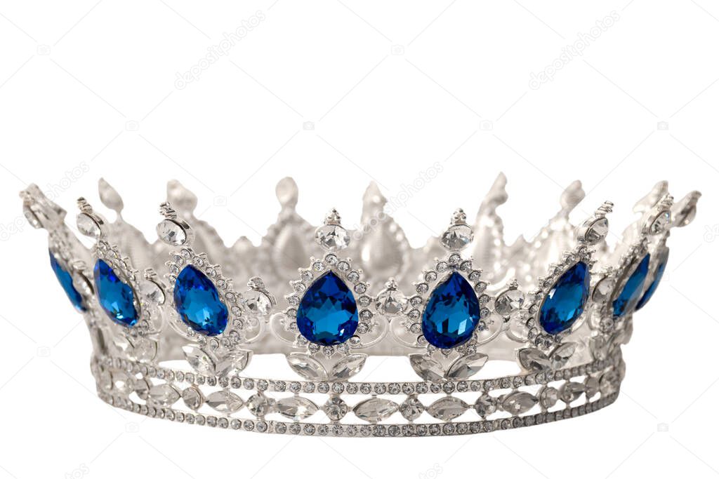 Beauty pageant winner, bride accessory in wedding and royal crown for a queen concept with a silver tiara covered in crystals, diamond and blue sapphire stones isolated on withe with clip path cutout
