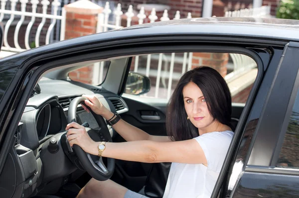 Woman in her late 30s to early 40s in a car happy to have passed the driver license test — 图库照片