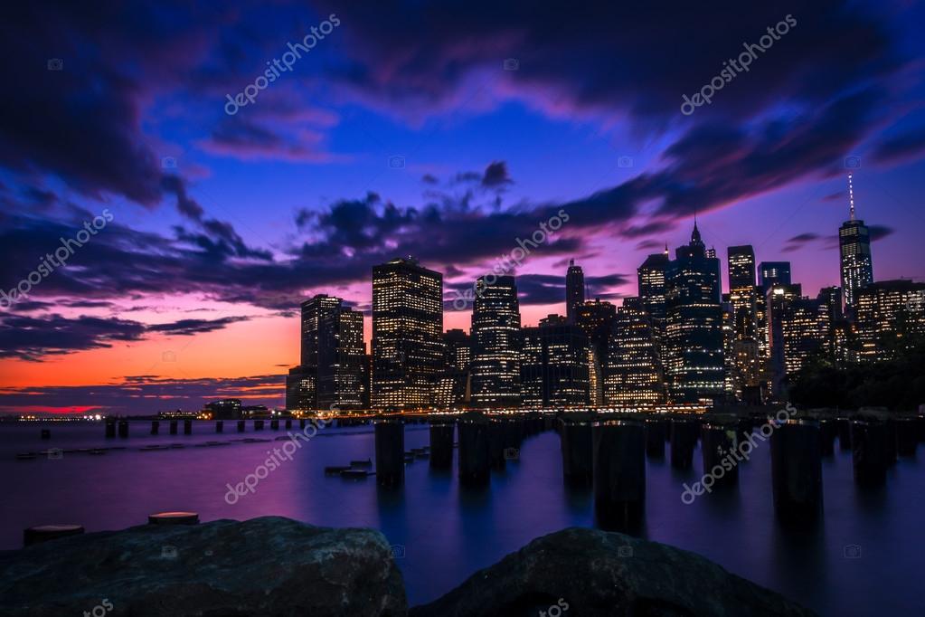 Фотообои New York skyline seen from Brooklyn across the east river with some wooden pylons