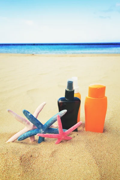 Creme abbronzanti sulla spiaggia sabbiosa — Foto Stock