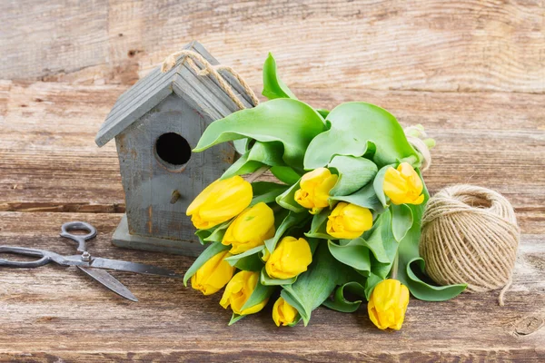 Yellow tulips  with birdcage — Stock Photo, Image