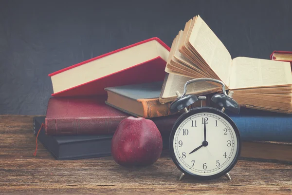 Pile of books with clock — Stock Photo, Image