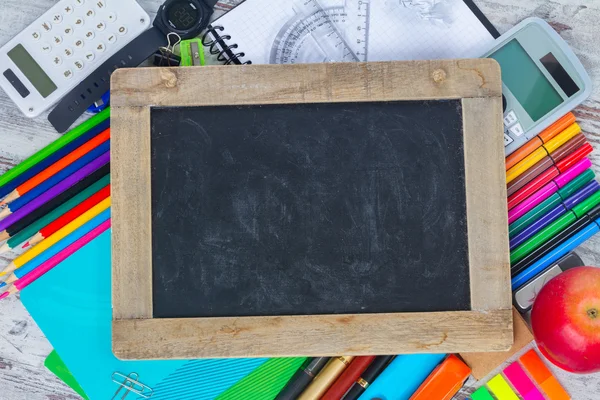 Chalkboard and school supplies — Stock Photo, Image