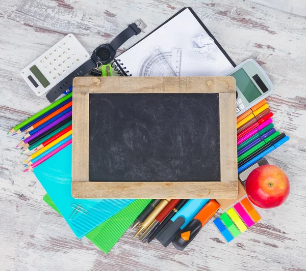 Chalkboard and school supplies — Stock Photo, Image