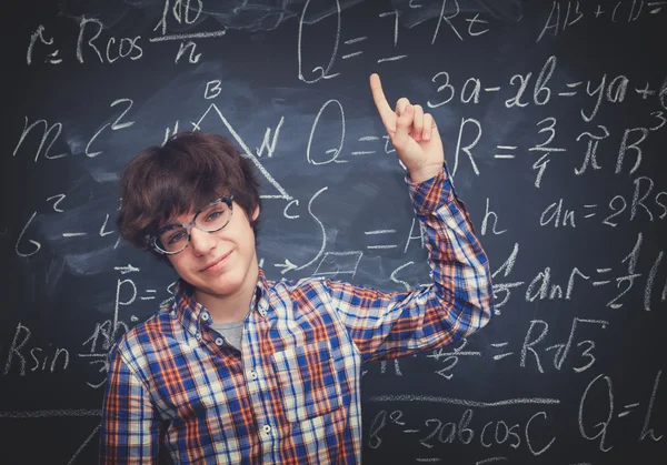 Pojke och blackboard fylld med matematiska formler — Stockfoto