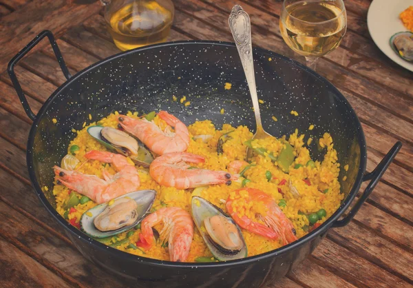 Seafood paella in black pan — Stock Photo, Image