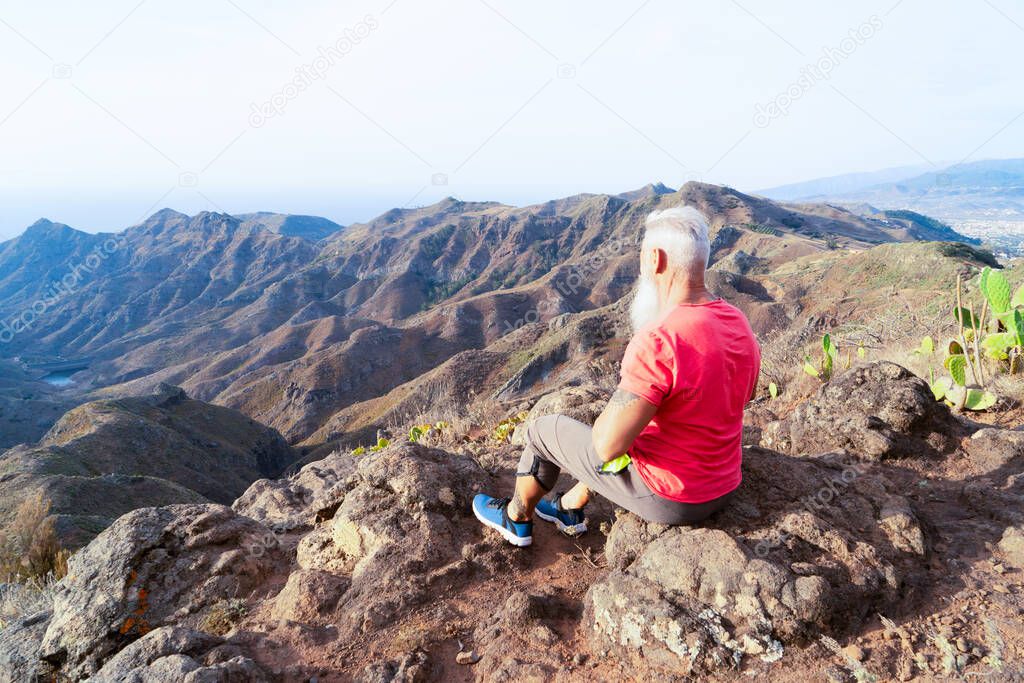 Senior man greeting sunset