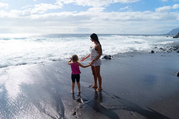 Zdrowa szczęśliwa rodzina mama i córka robi ćwiczenia rozciągające na wybrzeżu — Zdjęcie stockowe