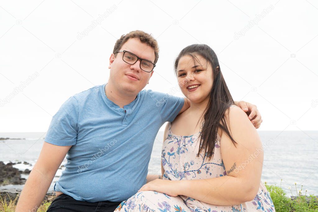 couple in love kissing each other while spending time outdoors on seaside