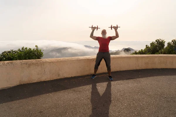 Senior man doing sport exercises