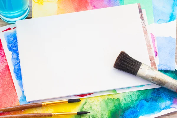 White canva with frame of paints and brushes — Stock Photo, Image