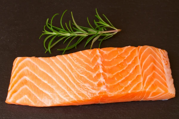 Salmon steak with twig of rosemary — Stock Photo, Image