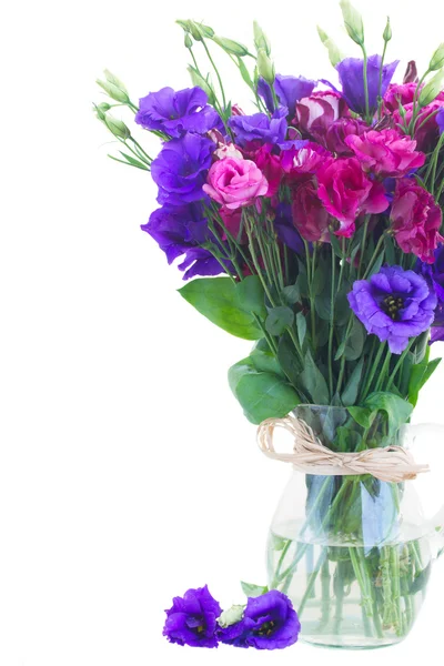 Violet and mauve eustoma flowers in glass vase — Stock Photo, Image