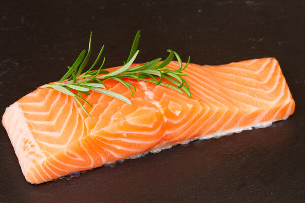 salmon steak with twig of rosemary