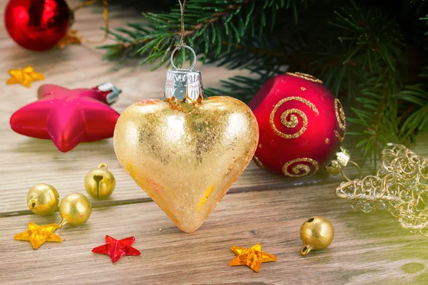 Golden heart on fir tree — Stock Photo, Image