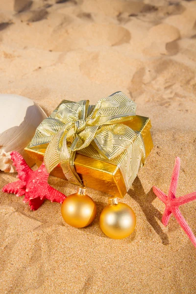 Christmas gifts on beach — Stock Photo, Image